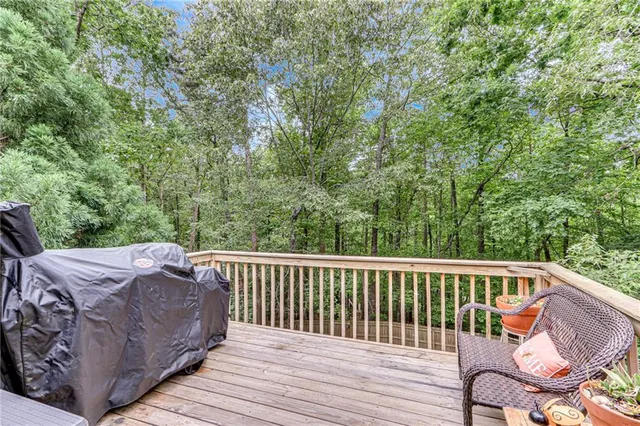 a backyard of a house with lawn chairs and iron fence