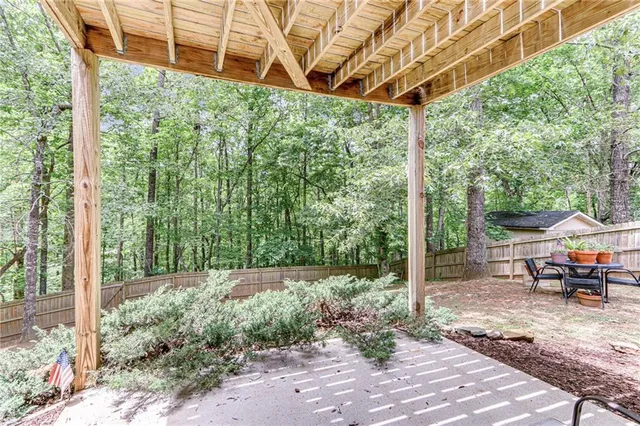 a view of a patio with a table and chairs and wooden floor
