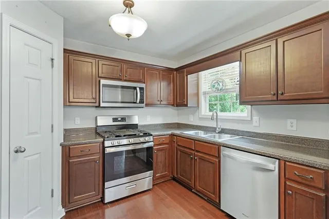 a kitchen with stainless steel appliances granite countertop a stove and a refrigerator