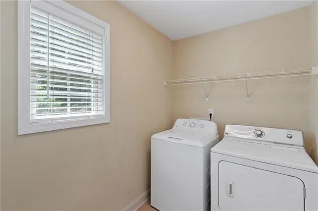 a bedroom with a large bed chandelier and a window