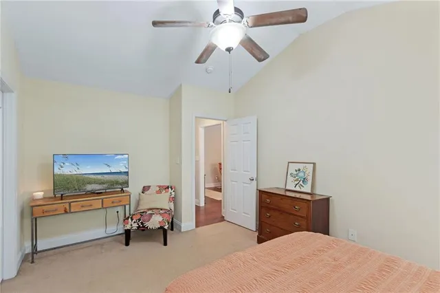 a bathroom with a granite countertop sink a toilet and a mirror