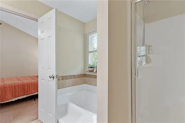 a white bath tub sitting in front of a window