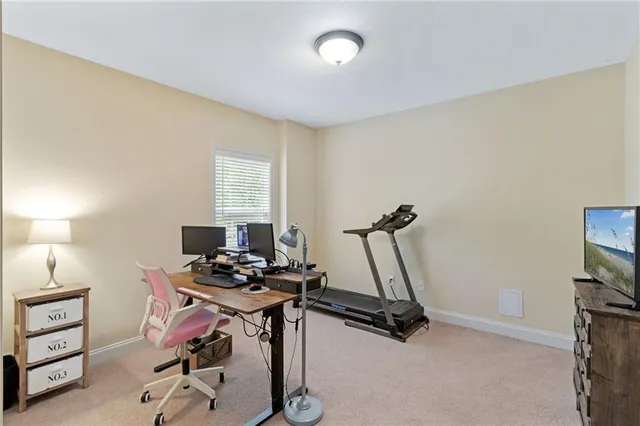 a view of a workspace with furniture and a window