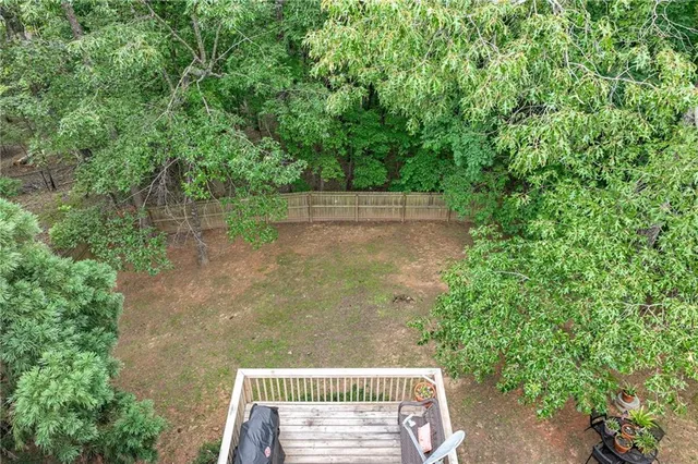 a view of a house with a deck and a yard