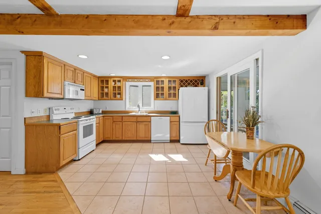 a dining room with furniture a rug and a large window