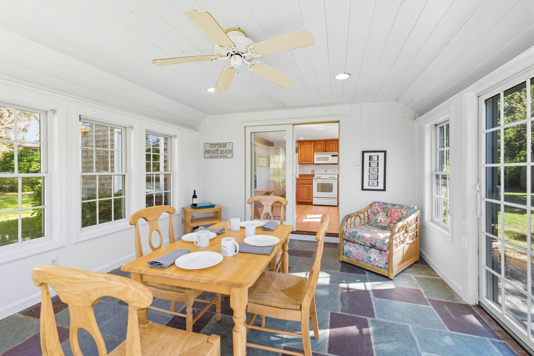 20 Spring Lane Brewster, MA 02631 - Photo 17 of 56 a dining room with furniture a rug and a large window