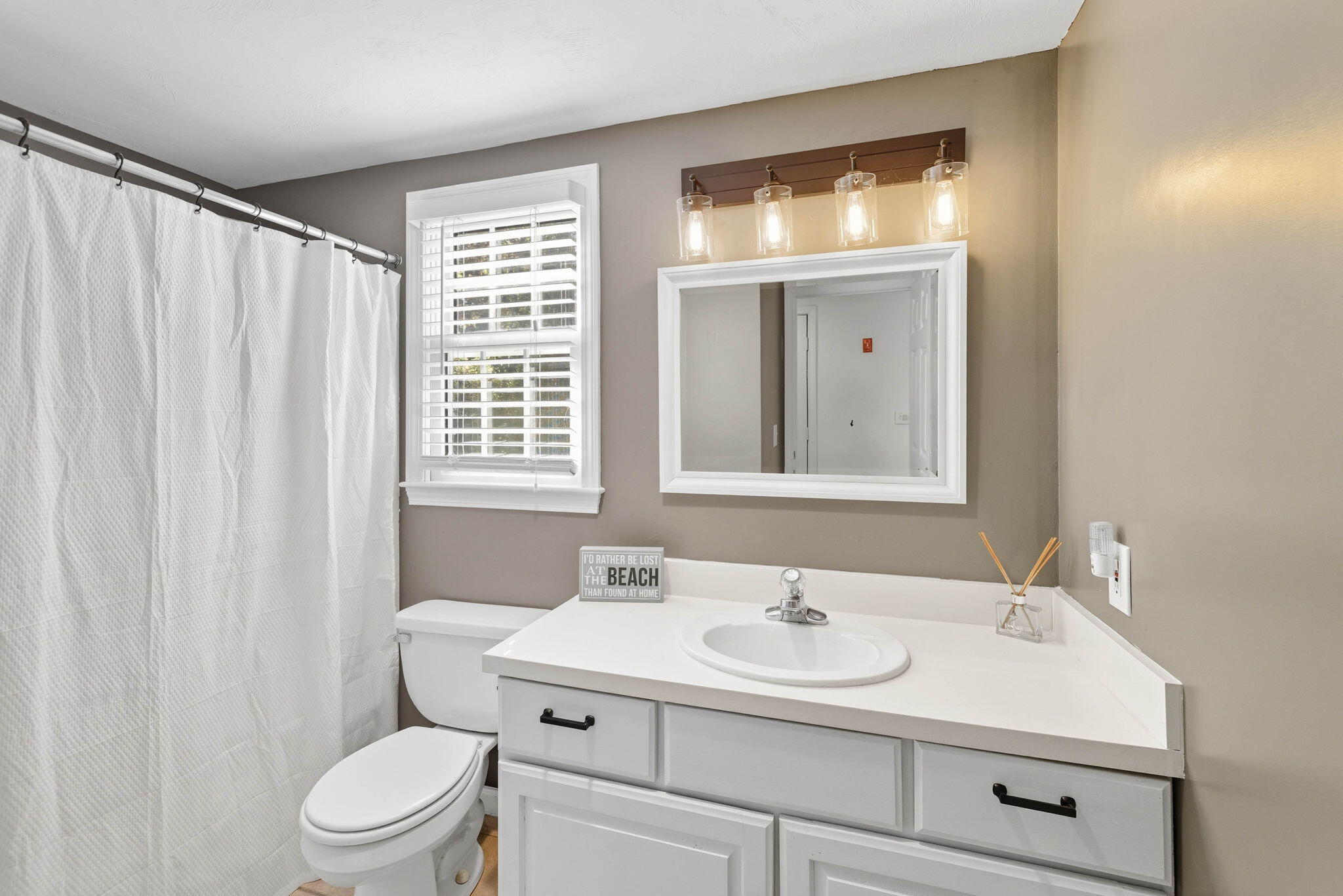 20 Spring Lane Brewster, MA 02631 - Photo 21 of 56 a bathroom with a sink a toilet and a mirror