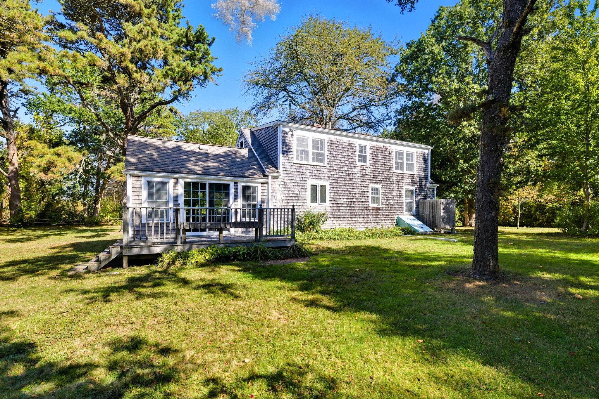 20 Spring Lane Brewster, MA 02631 - Photo 32 of 56 a view of a house with a yard patio and a tree