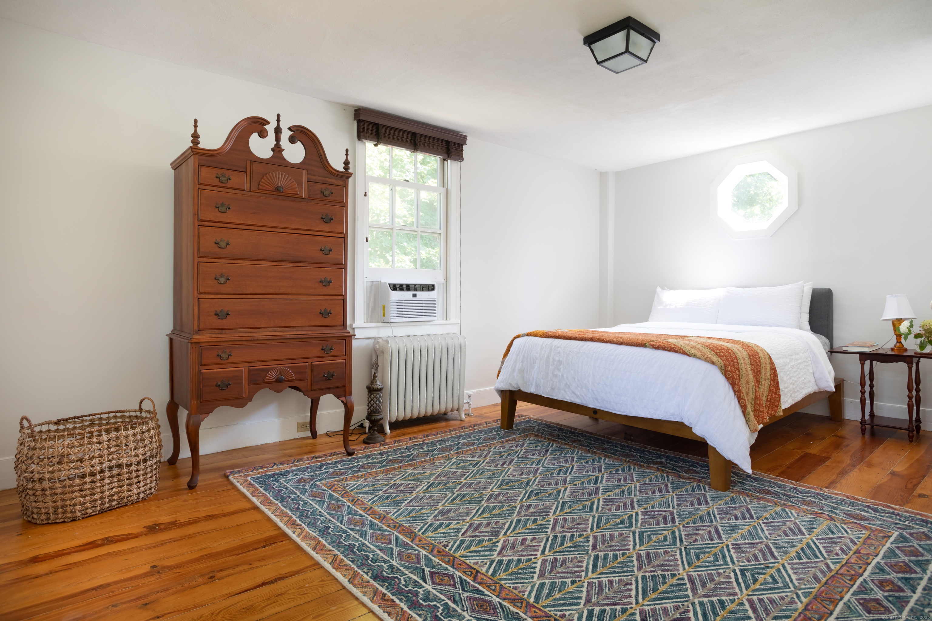30 Indian Mountain Road Lakeville, CT 06039 - Photo 13 of 17 a bedroom with a bed and wooden floor