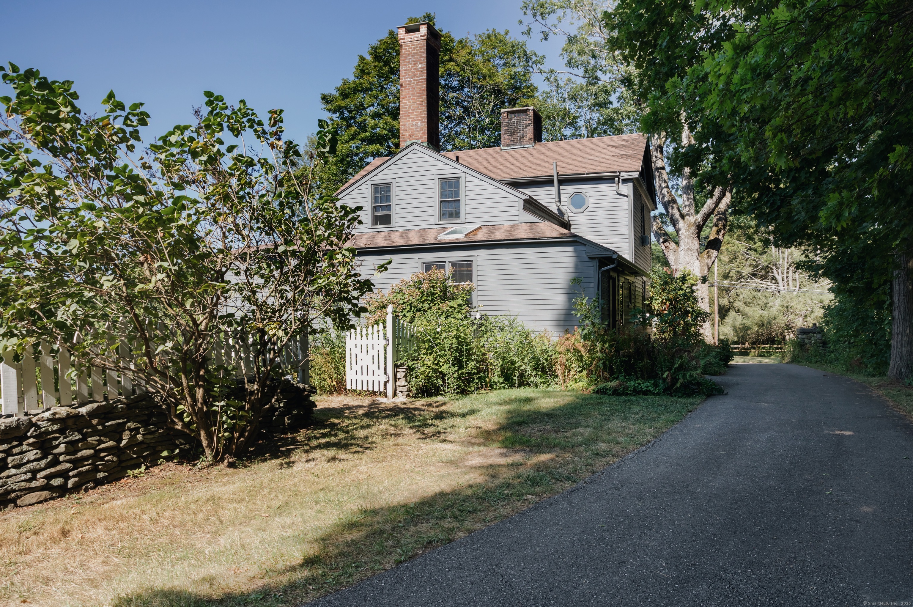 30 Indian Mountain Road Lakeville, CT 06039 - Photo 2 of 17 a view of a house with a small yard and large trees