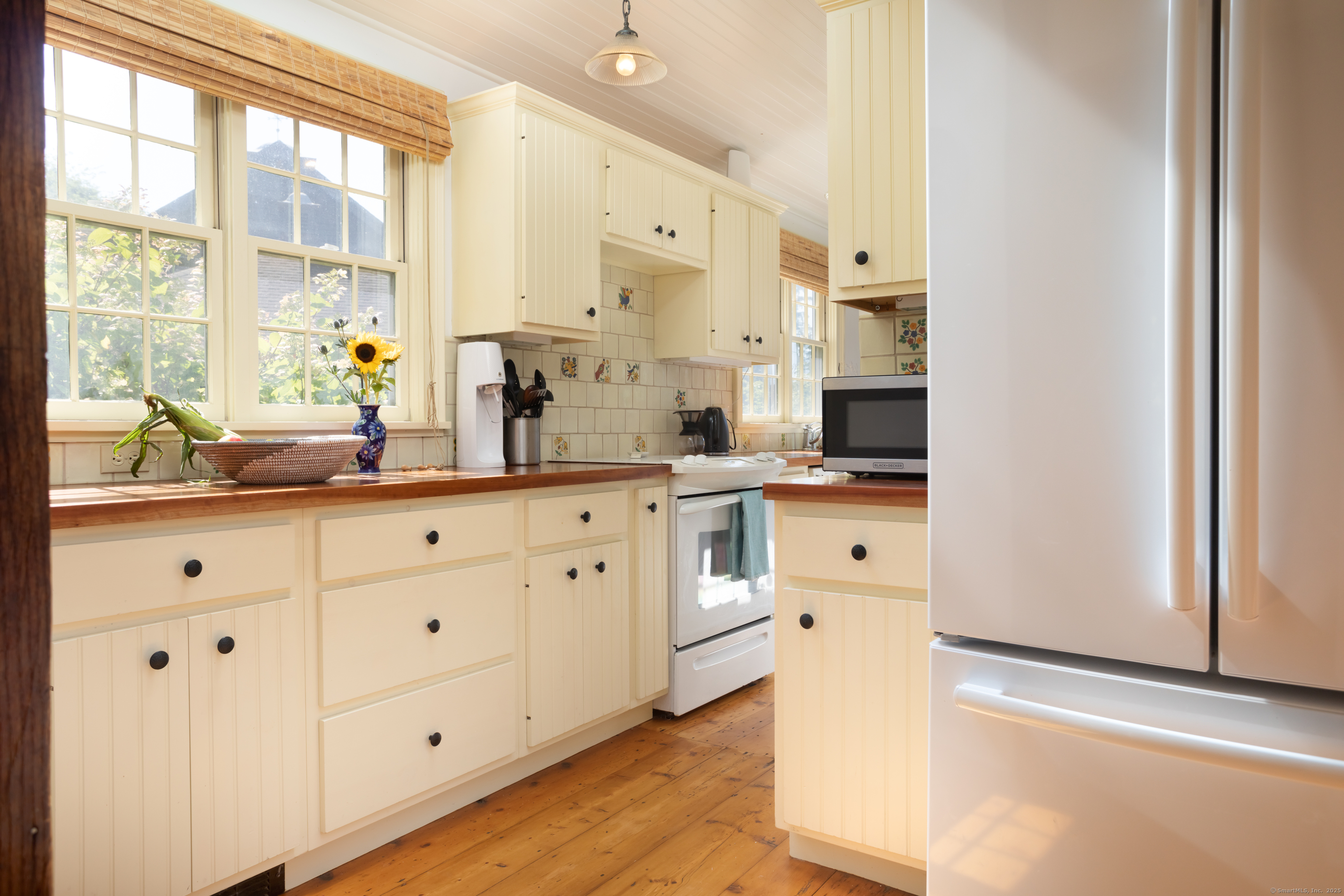30 Indian Mountain Road Lakeville, CT 06039 - Photo 3 of 17 a large white kitchen with granite countertop a large window and white stainless steel appliances