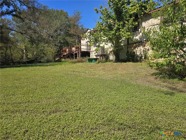 a view of a field with trees