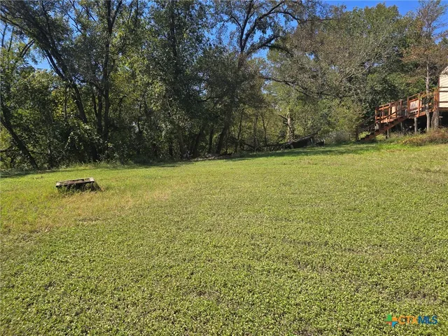 a view of a swimming pool and trees in the background