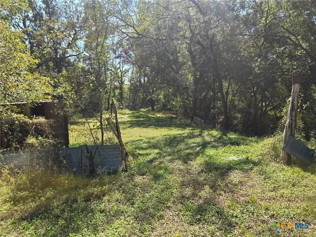 a backyard of a house with a yard and outdoor seating