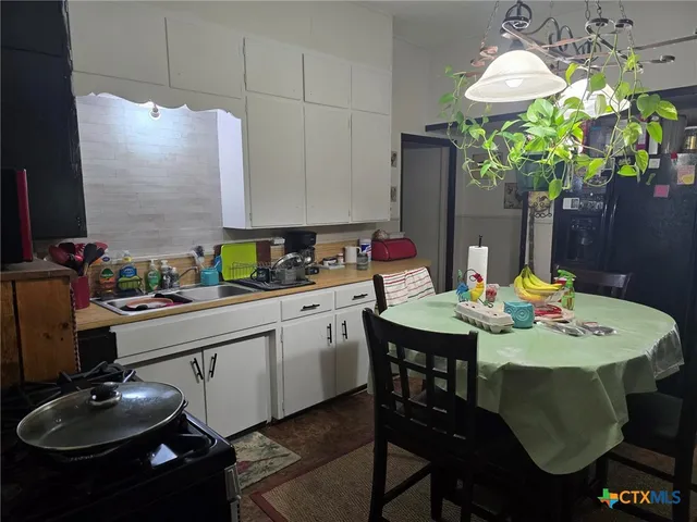 a dining room with furniture and chandelier