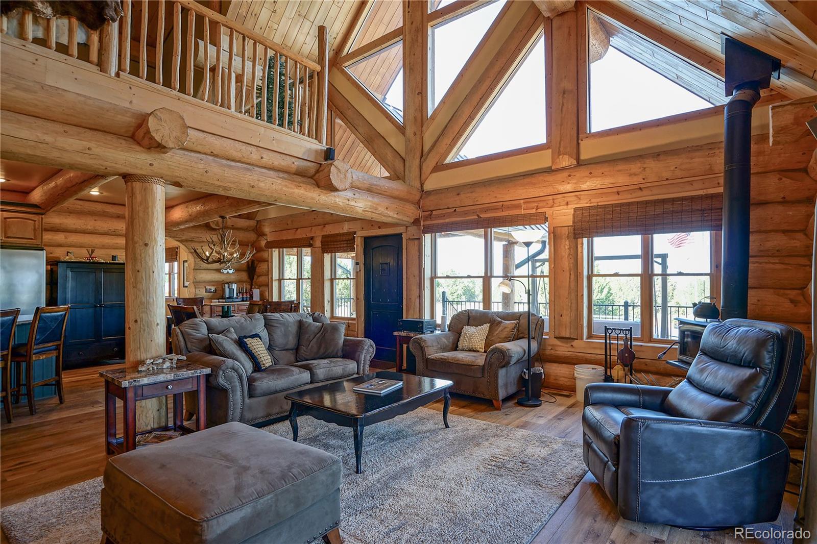 810 Mustang Road Rye, CO 81069 - Photo 11 of 50 a living room with furniture a fireplace and a large window