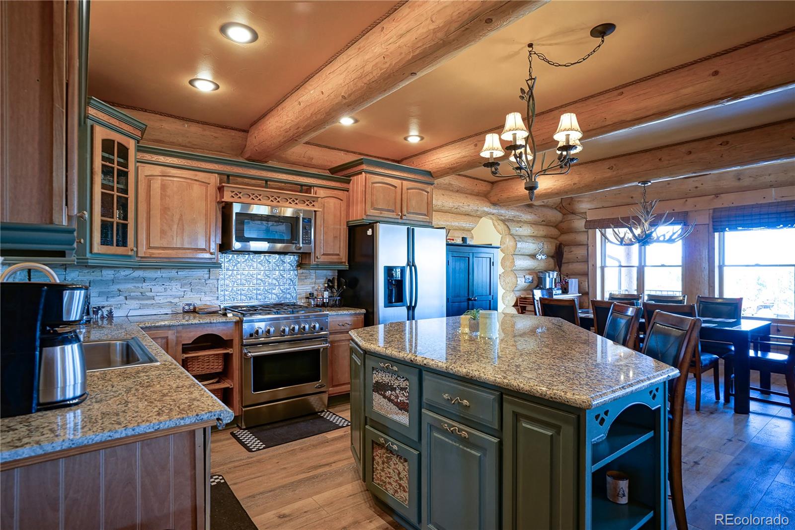 810 Mustang Road Rye, CO 81069 - Photo 15 of 50 a kitchen with a stove a kitchen island a dining table and chairs