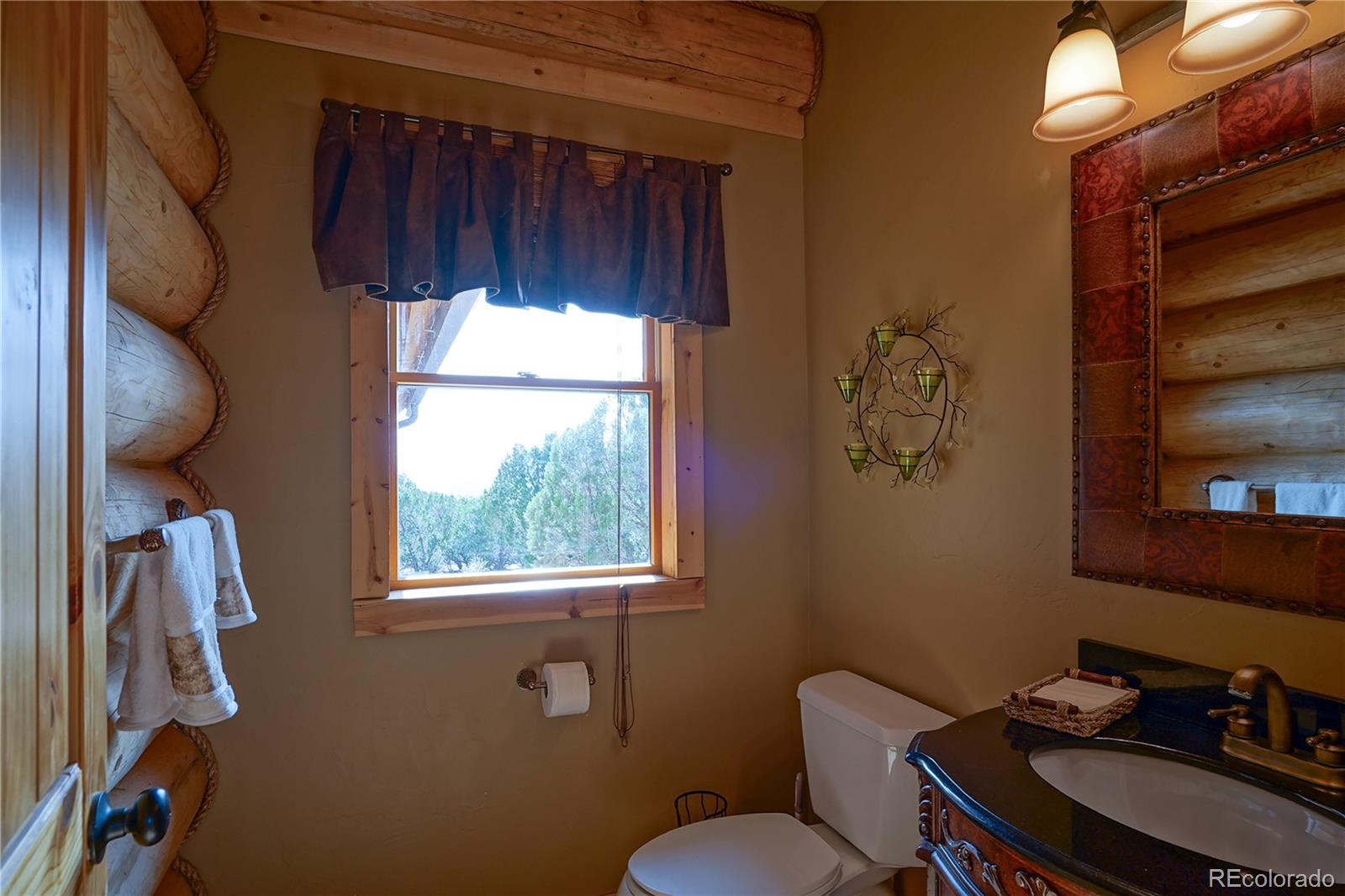 810 Mustang Road Rye, CO 81069 - Photo 19 of 50 a bathroom with a toilet a sink and a window