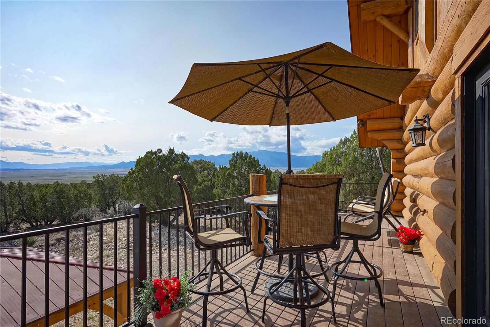 810 Mustang Road Rye, CO 81069 - Photo 22 of 50 a view of a balcony with furniture and umbrella