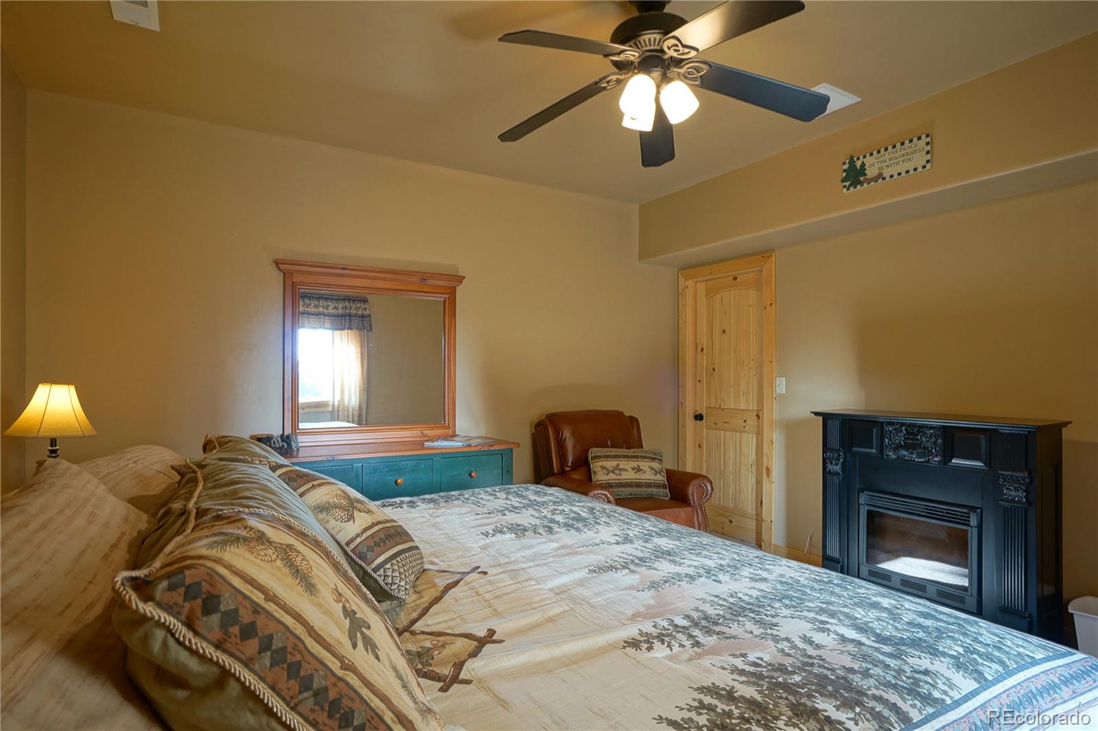 810 Mustang Road Rye, CO 81069 - Photo 39 of 50 a bedroom with a bed and a fireplace