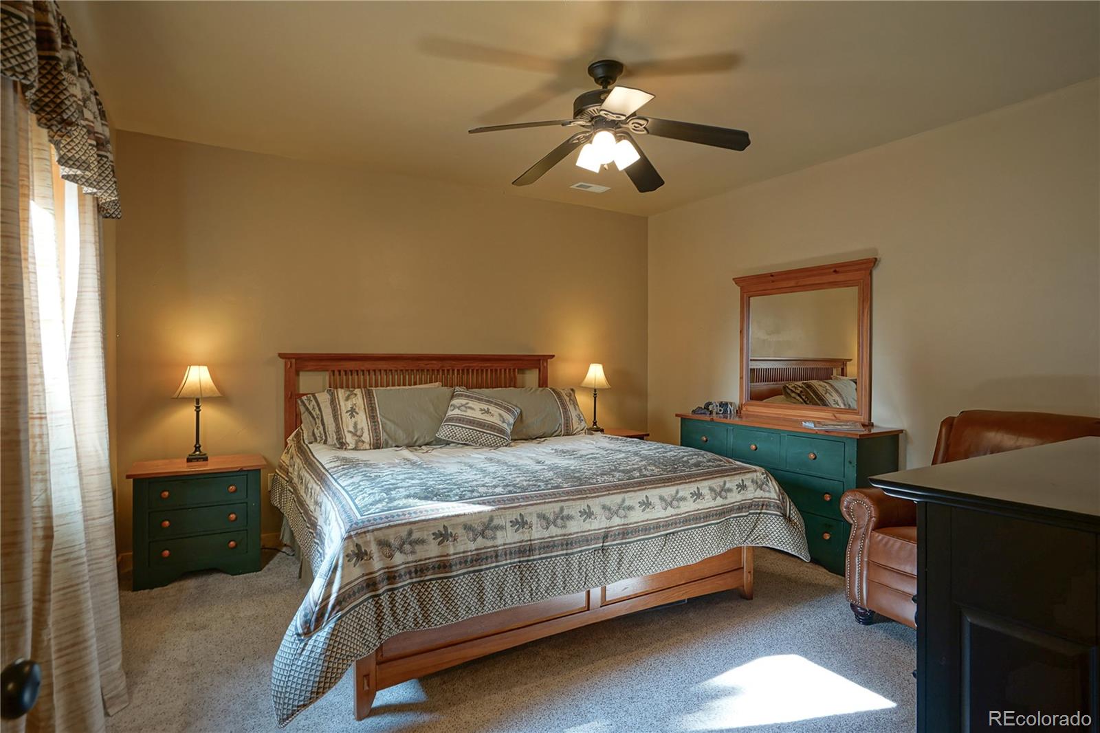 810 Mustang Road Rye, CO 81069 - Photo 40 of 50 a bedroom with a bed and a chandelier