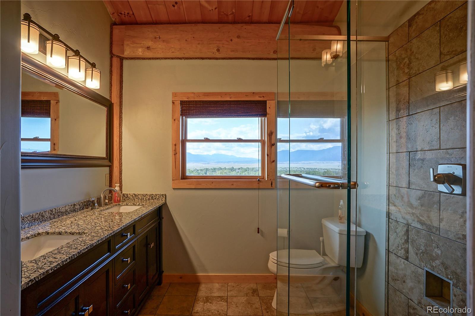 810 Mustang Road Rye, CO 81069 - Photo 41 of 50 a bathroom with a granite countertop sink toilet and shower