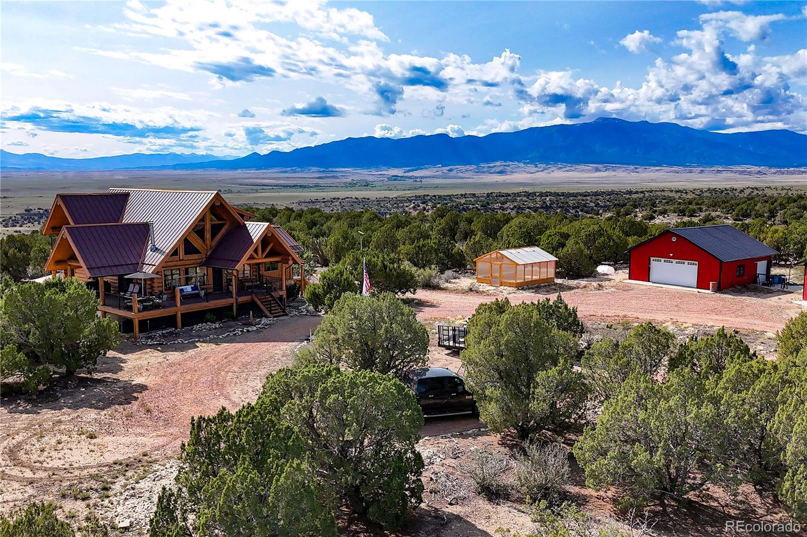 810 Mustang Road Rye, CO 81069 - Photo 44 of 50 a view of a terrace with a table and chairs under an umbrella