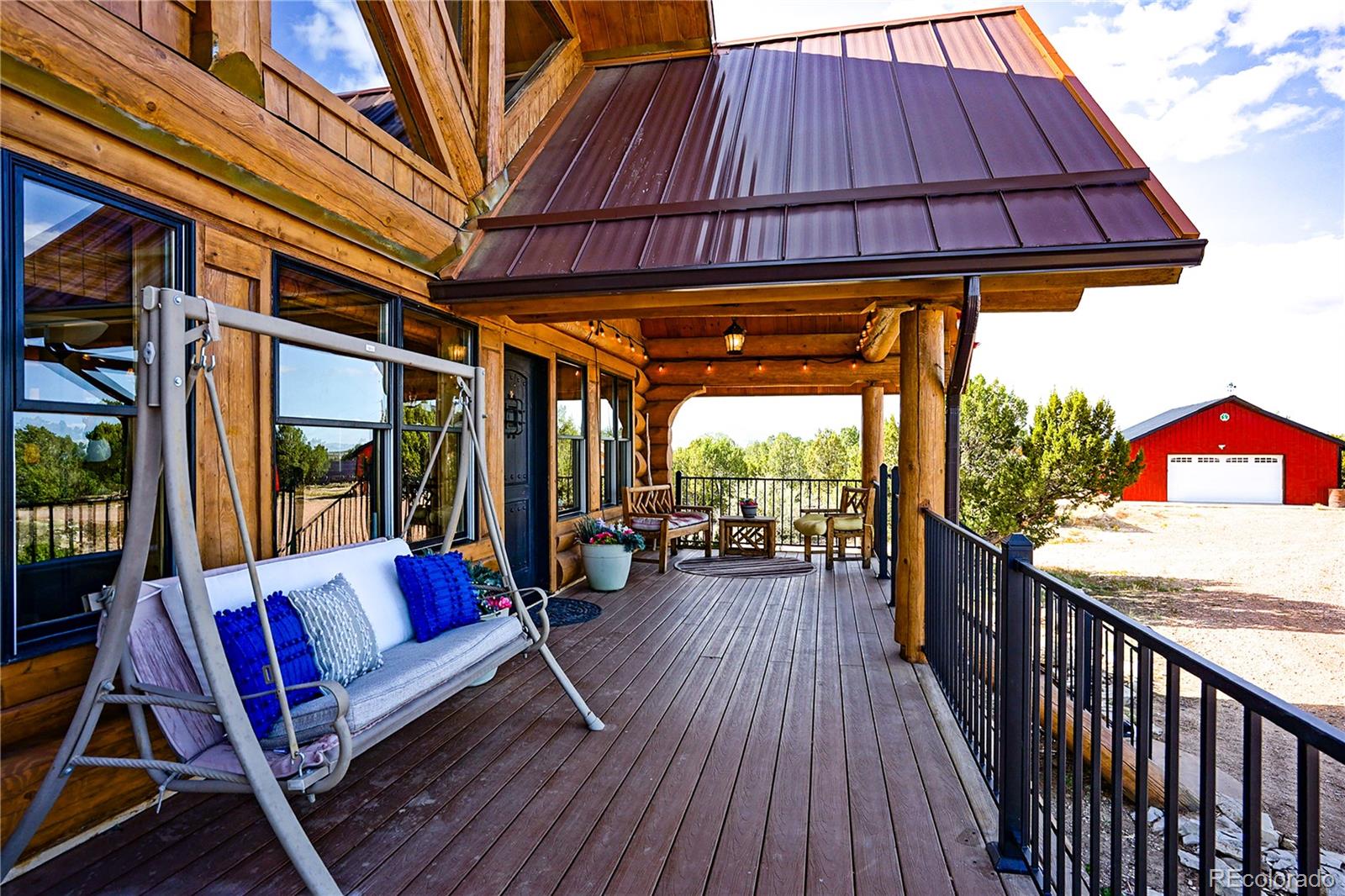 810 Mustang Road Rye, CO 81069 - Photo 10 of 50 a patio with wooden floor a yard a table and chairs