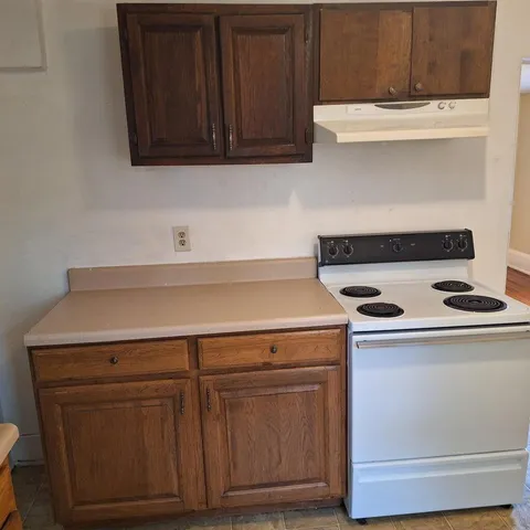 a stove top oven sitting inside of a kitchen