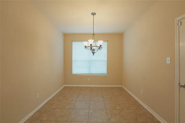 a dining room that has a chandelier and a window