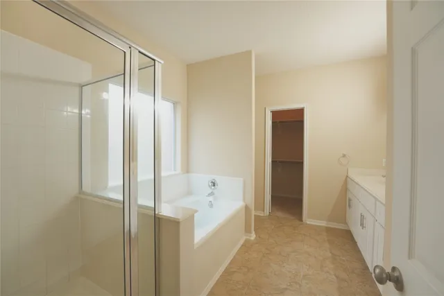 a bathroom with a tub and shower
