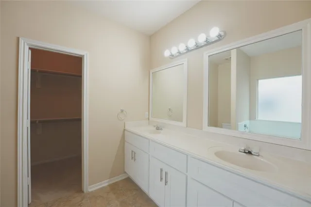 a bathroom with a double vanity sink mirror and double