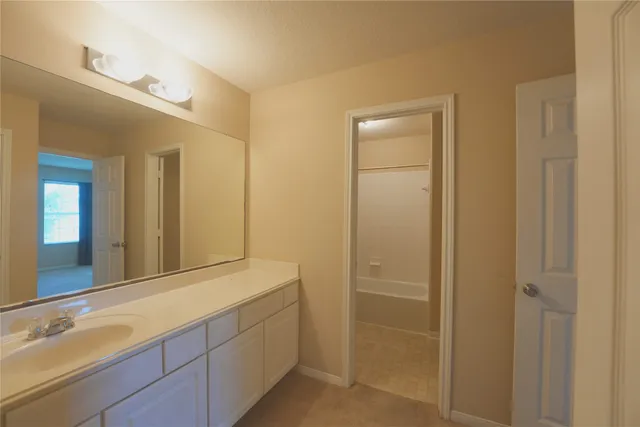 a bathroom with a double vanity sink and a mirror