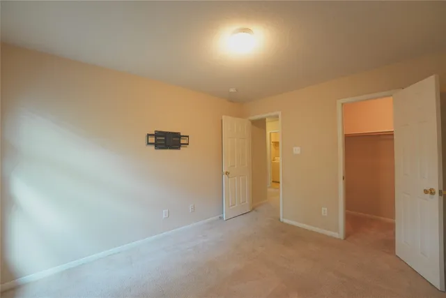 an empty room with a empty space and windows