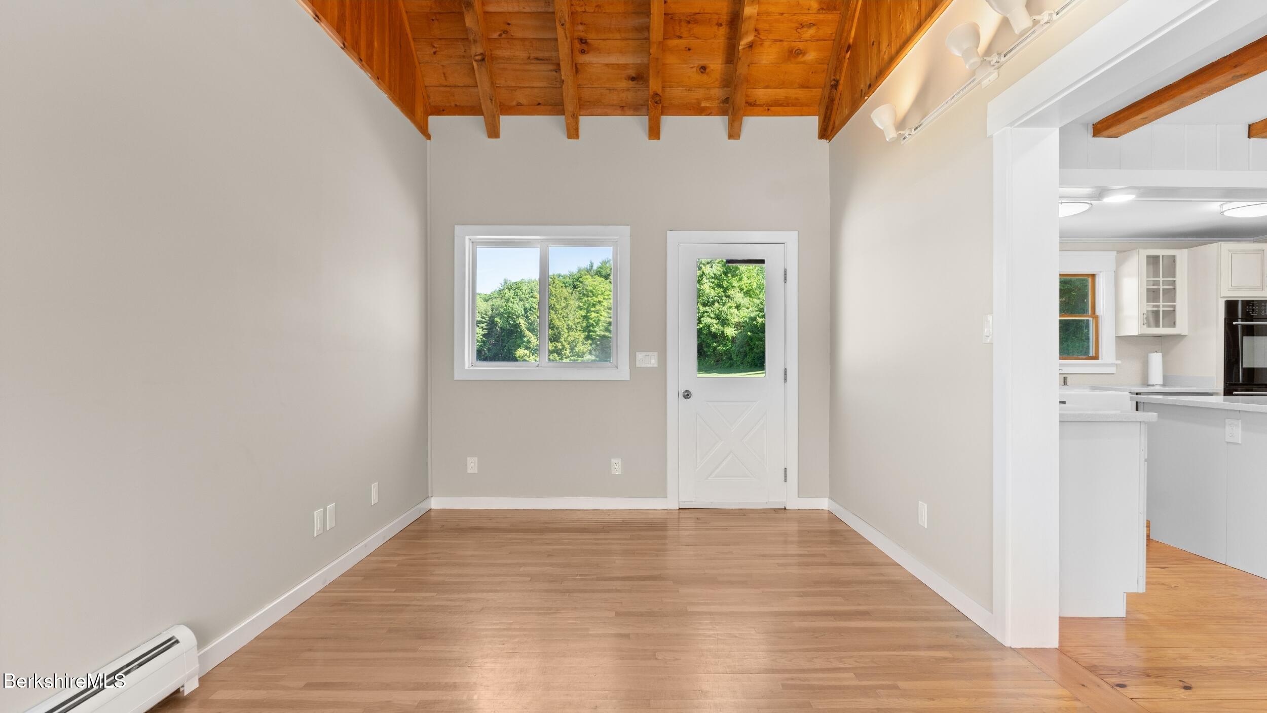 134 Hurlburt Road Great Barrington, MA 01230 - Photo 12 of 50 a view of an empty room with wooden floor and a window