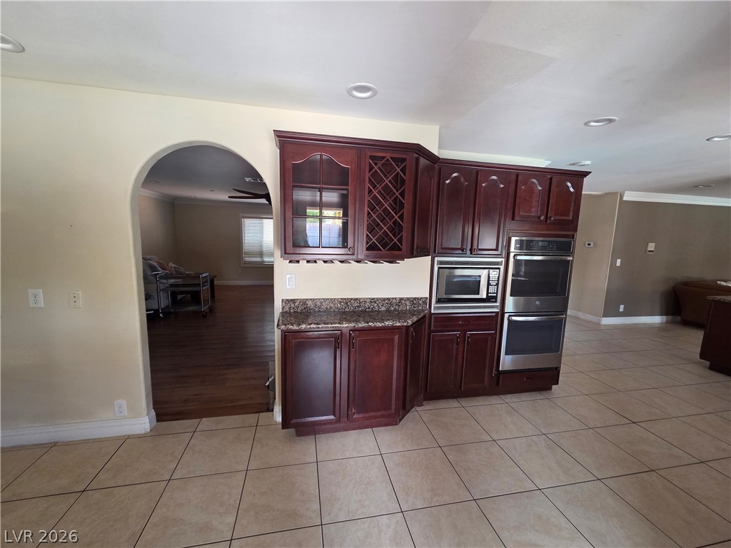 3381 Westwind Road Las Vegas, NV 89146 - Photo 30 of 52 A functional built-in bar with dark wood cabinetry and a wine rack for entertaining guests.
