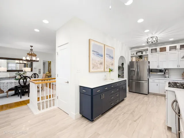 a kitchen with stainless steel appliances kitchen island granite countertop a refrigerator and a stove top oven