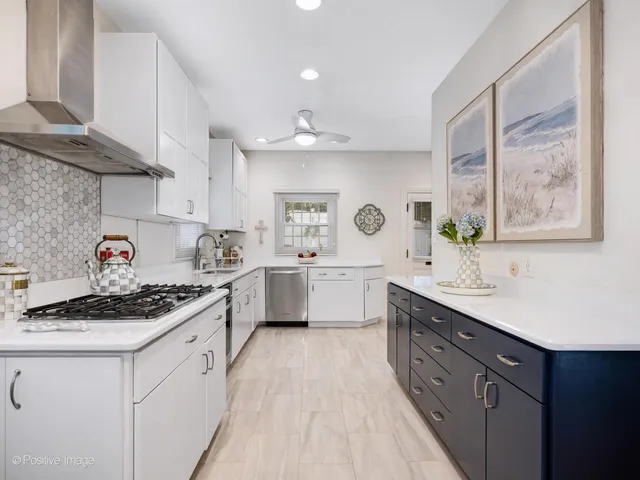 a kitchen with stainless steel appliances a sink stove and cabinets