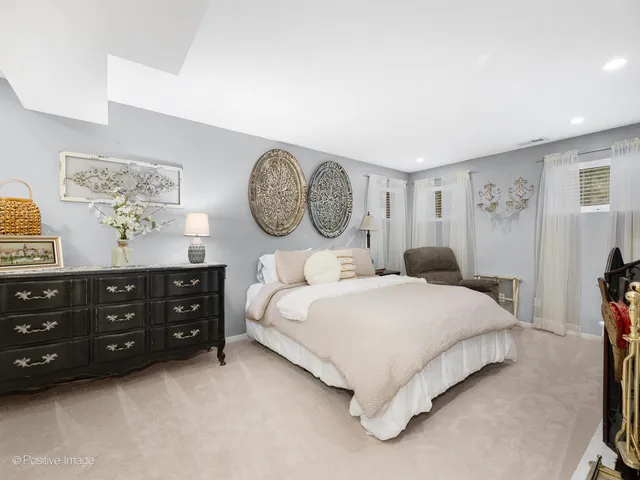 a bedroom with a bed and painting on the wall