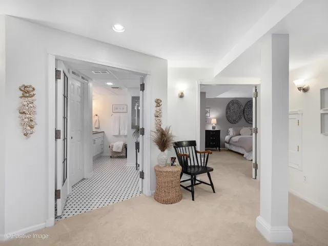 a living room with furniture and a mirror