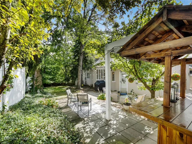 a chair and table sitting in backyard of the house