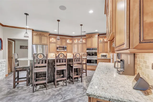 a large kitchen with a table and chairs