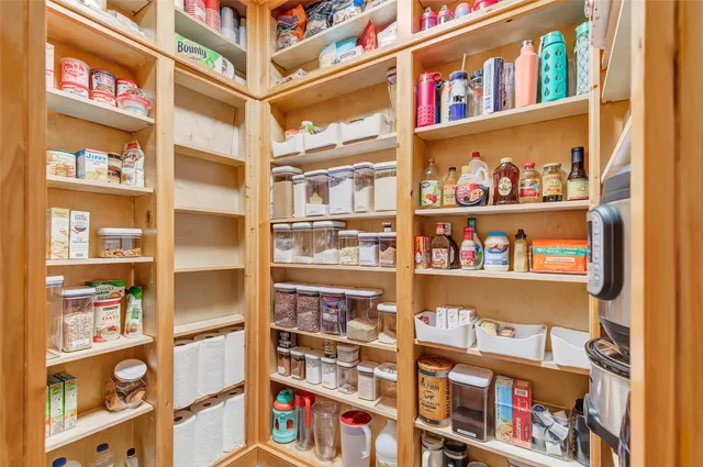 a dining room with furniture a chandelier and wooden floor