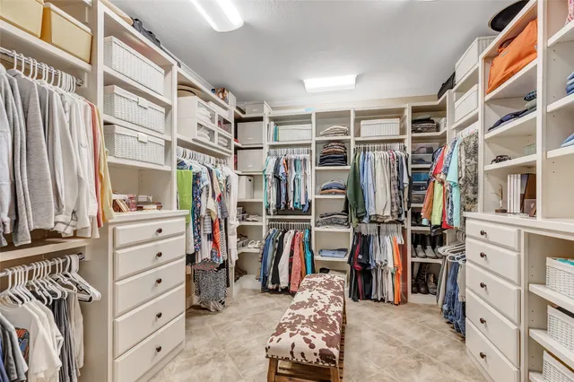 a spacious bathroom with a granite countertop sink a mirror a bathtub and next to a window