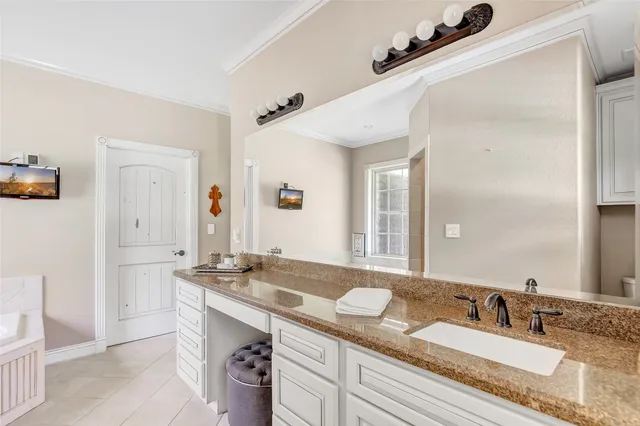 a bathroom with a tub a sink and a window