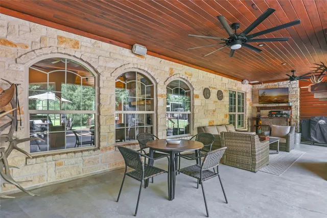 a dining room with furniture and a floor to ceiling window