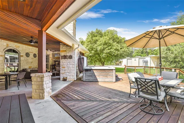 a view of balcony with wooden floor and outdoor seating