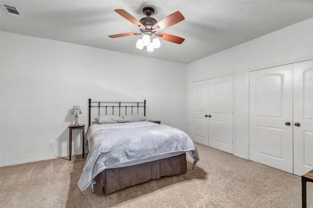 a bathroom with a granite countertop double vanity sink and a mirror