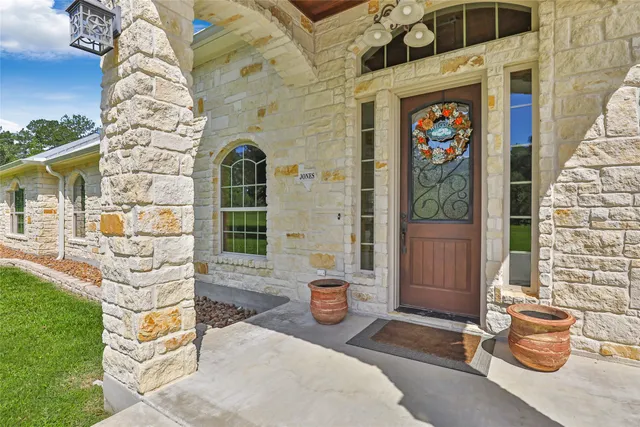 a living room with fireplace furniture and a wooden floor