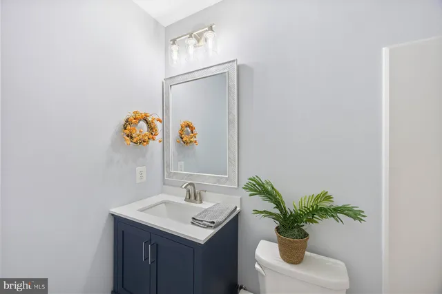 a bathroom with a sink a mirror and vanity